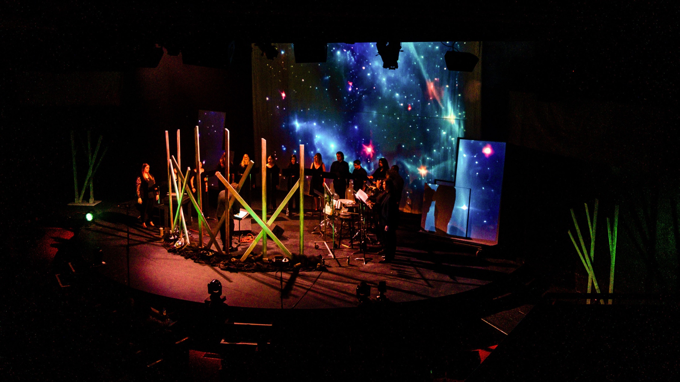 Verdigris Ensemble performing with a star-field projection and sculptural set pieces