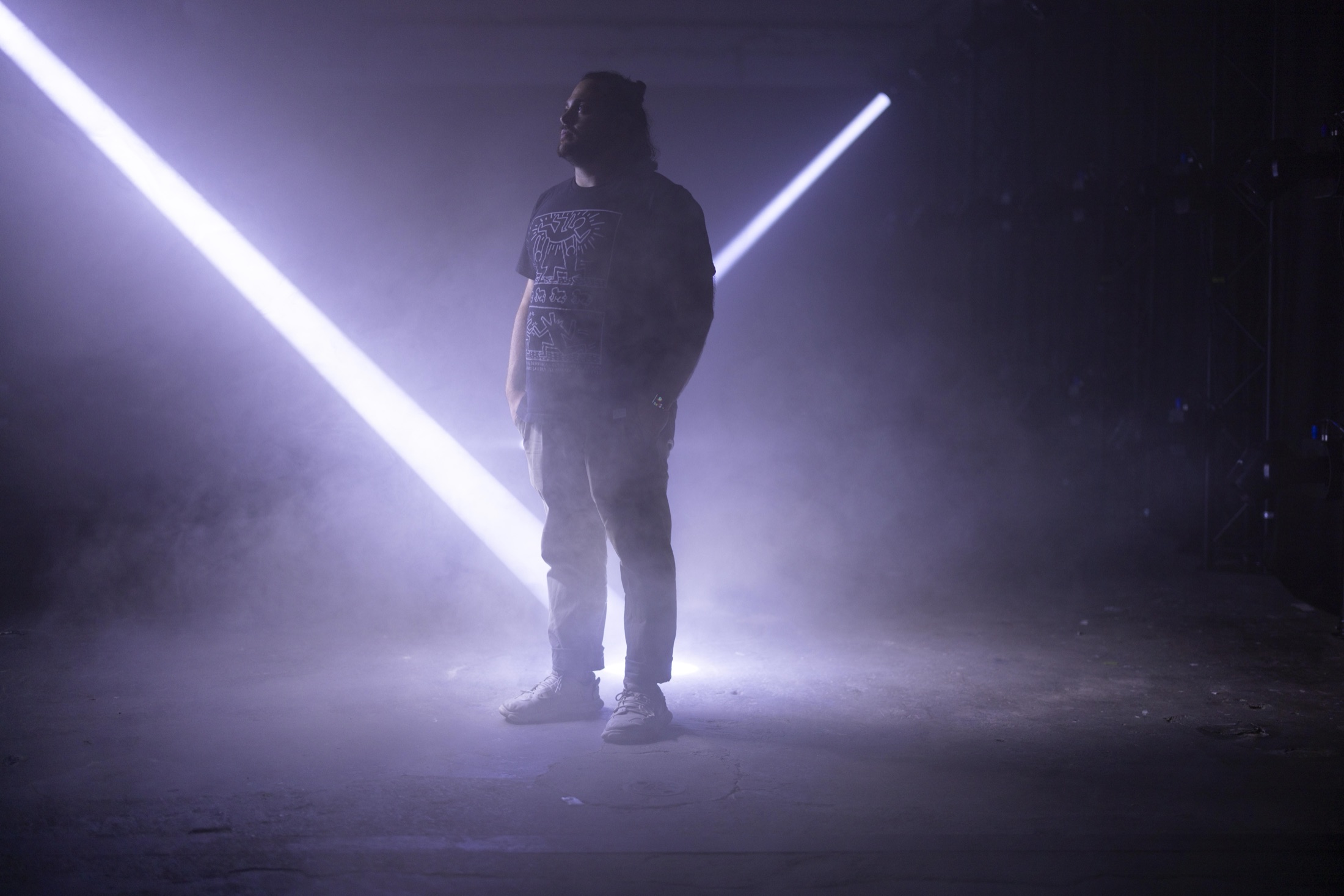 Sam standing among beams of light at ECLIPSE by NONOTAK