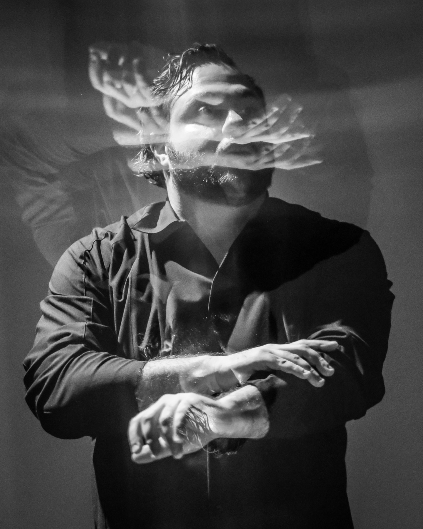 Performer in motion against projection during The Endangered