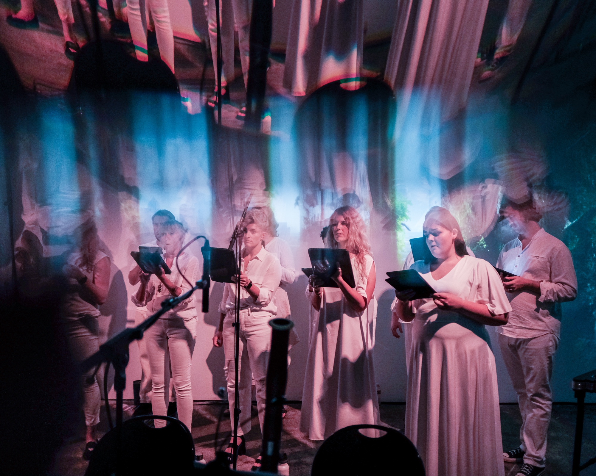 Verdigris Ensemble singers surrounded by AI-generated projection in The Endangered